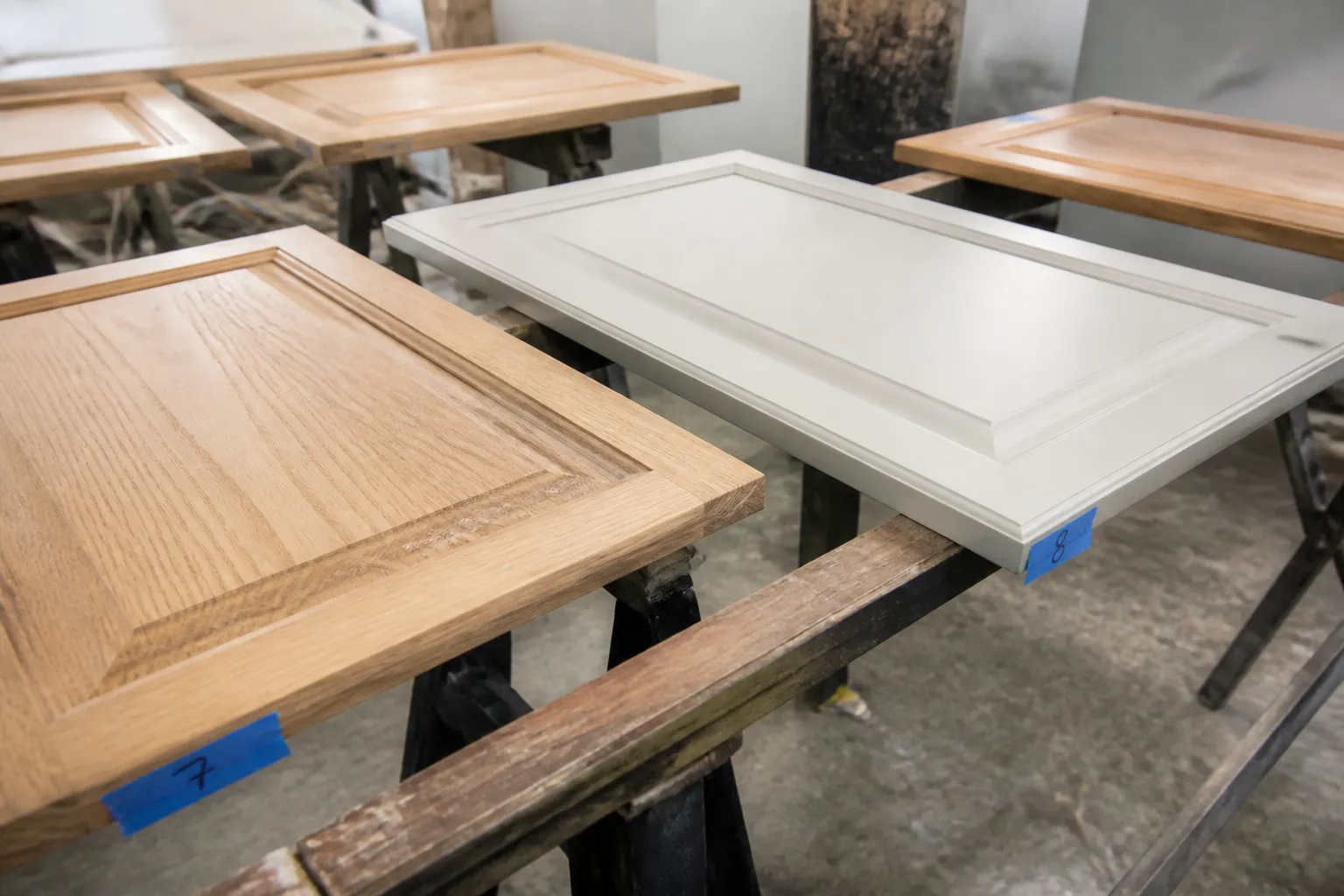 Kitchen cabinet doors numbered and sanded on sawhorses during a Tampa refinishing job