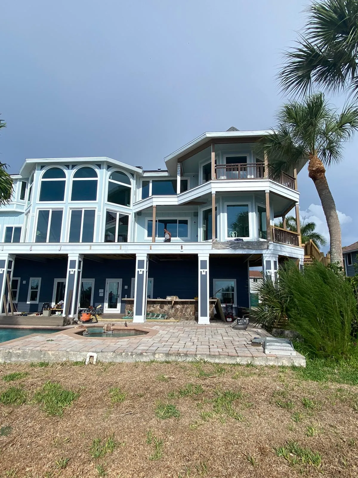 Mediterranean-style coastal home exterior painting with trim detail