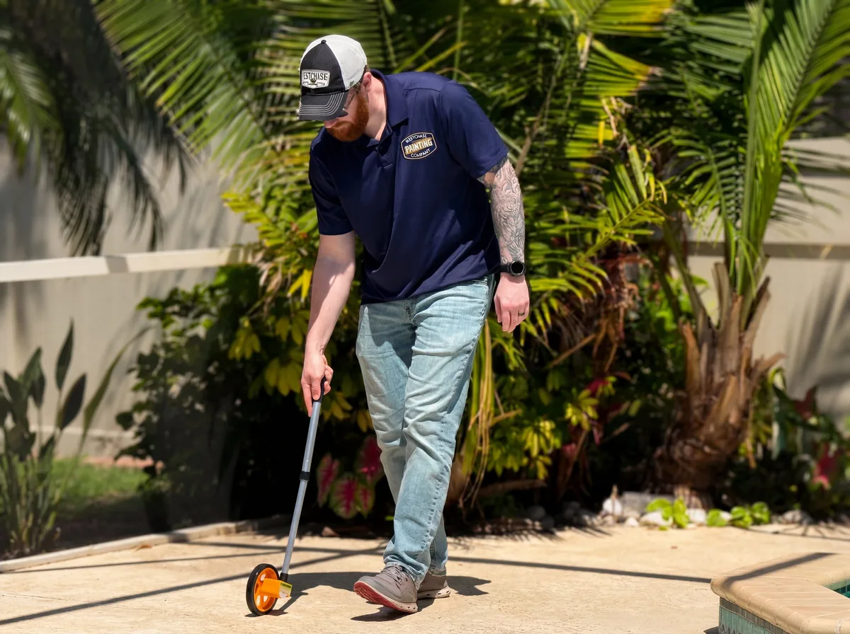 John Tortorich, Director of Field Operations at Westchase Painting Company, measuring a Tampa Bay pool deck